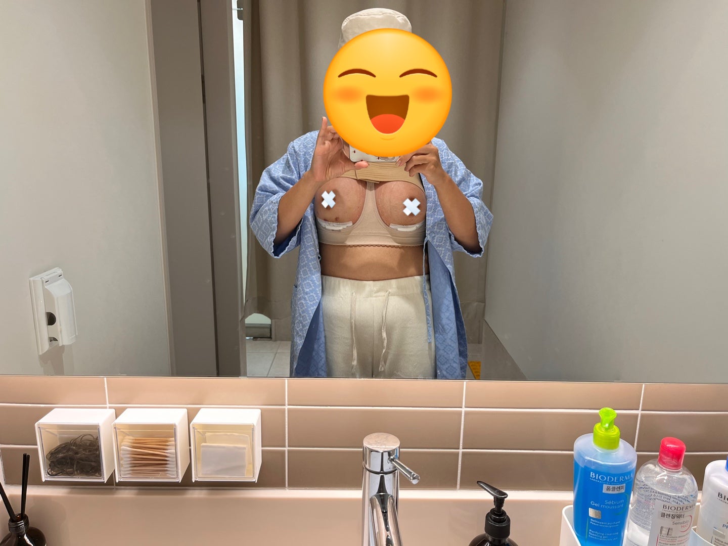 Real Korean cafe review photo — Day 1 after Mentor breast augmentation, patient in a mirror selfie wearing the post-op compression band and bra (face and nipples blurred for privacy)
