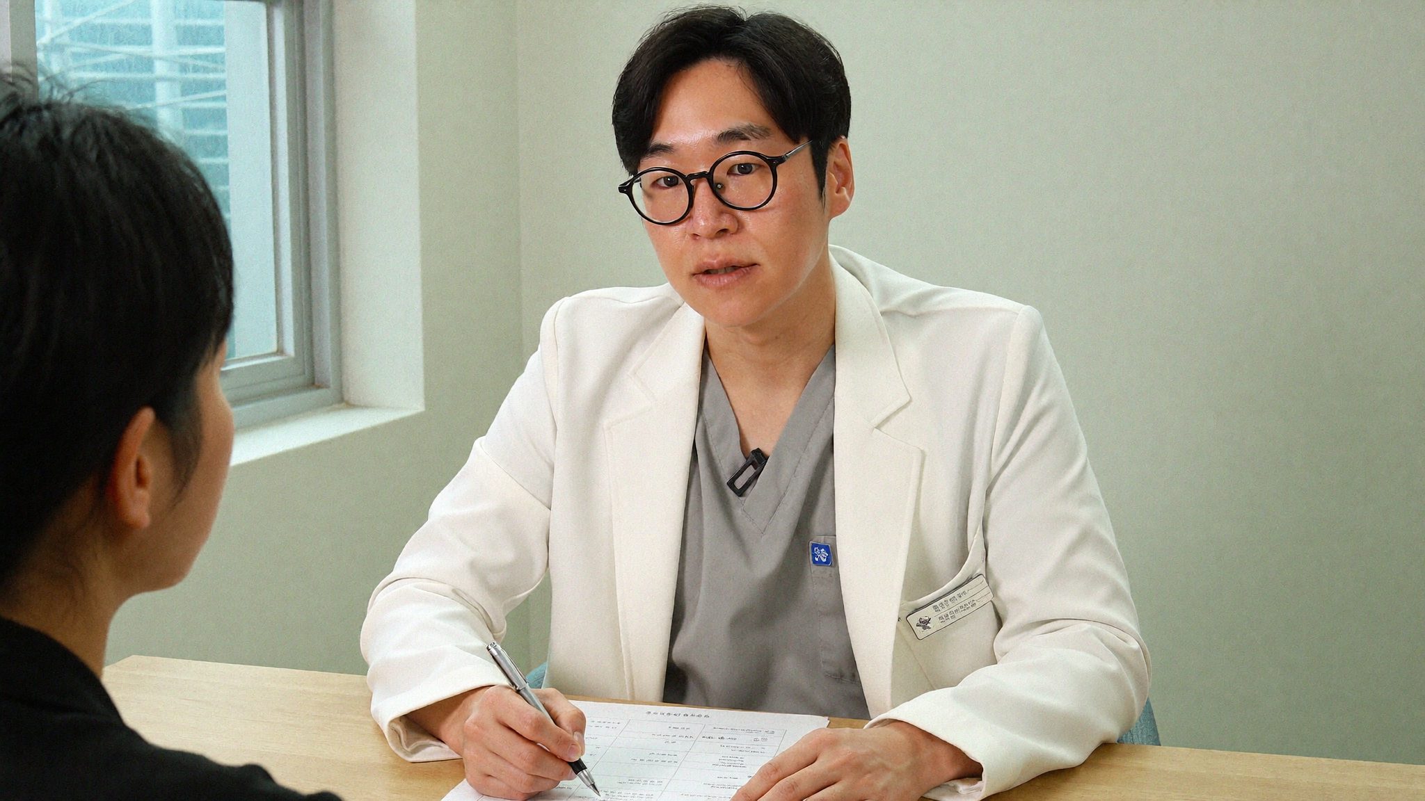 Dr. Sung Ha Min, co-director at Link Plastic Surgery, going through a surgical plan with an international patient.